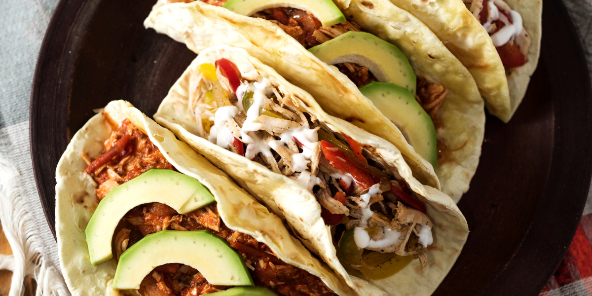 rotisserie chicken taco topped with avocado