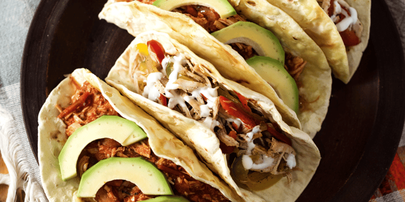 rotisserie chicken tacos with avocado on top