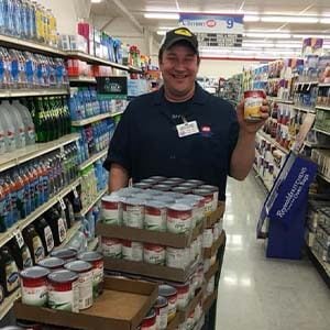 Bakery Manager Jason Gossett with 150 cans of vegetables