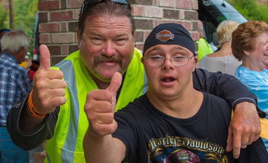 Guy and kid giving thumbs up