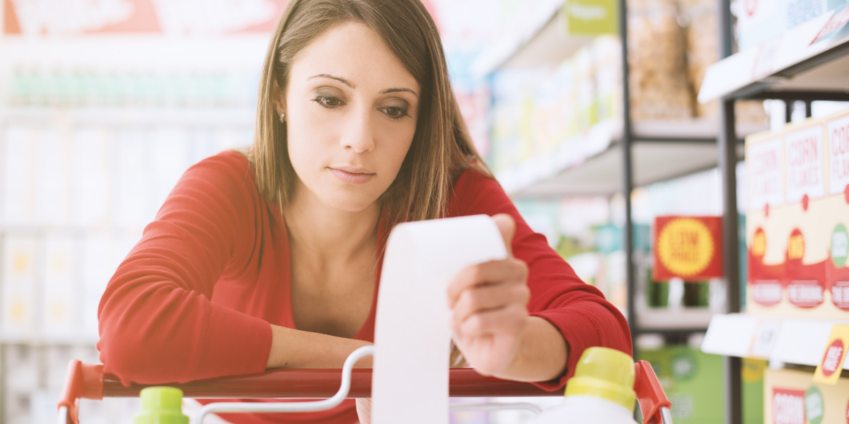 shopper reads receipt in store