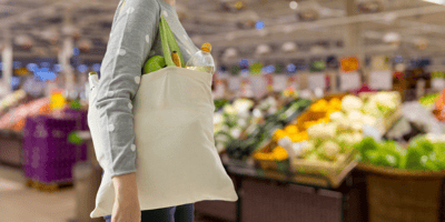 Shopper in store with reusable shopping bag