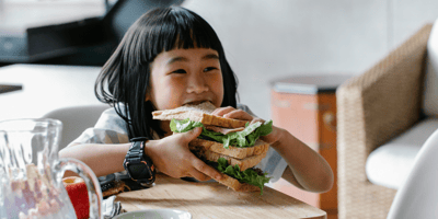 Girl eats giant sandwich