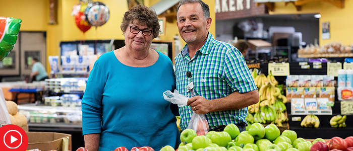 Brooks Marsh posing in produce section of grocery store while shopping