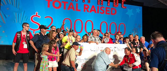Dream Ride Experience with group of people on stage holding $2 million check