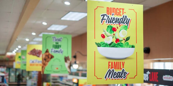 Budget-friendly family meals sign in an IGA store