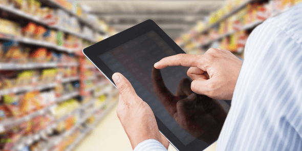 Surveyor inputs data into tablet in grocery aisle