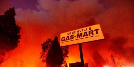 Greenville Gas Mart sign amongst flames