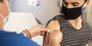 A person receives a bandage post-vaccination