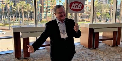 ricky st john holds an IGA sign