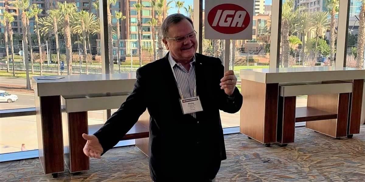 Ricky St. John holds an IGA sign