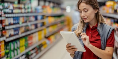 grocery worker on tablet in aisle