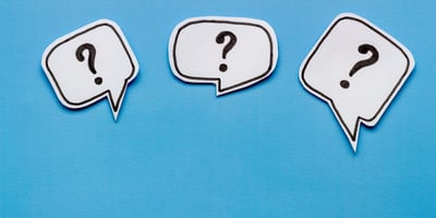 3 question mark bubbles on a blue background