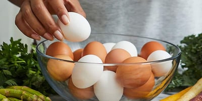 white and brown eggs in a glass bowl