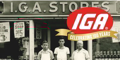 Vintage photo of IGA store and owners with IGA Centennial logo