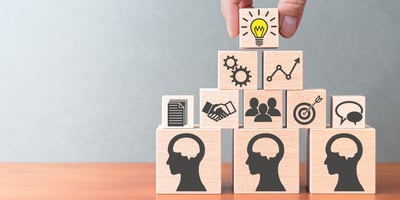 Building blocks with icons representing collaboration