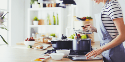 person cooking at stove