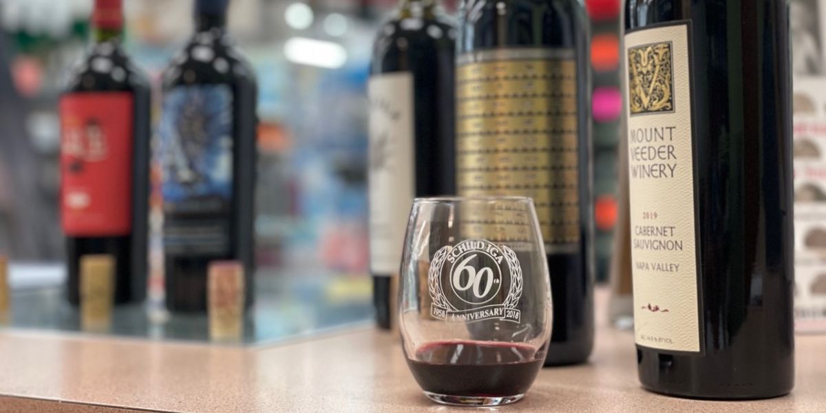 Schild's IGA wine glass next to wines