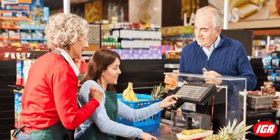 a shopper speaks with a trainee and manager at the supermarket