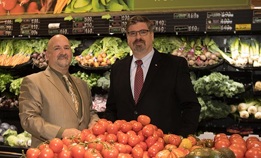 men dressed in suits in produce section