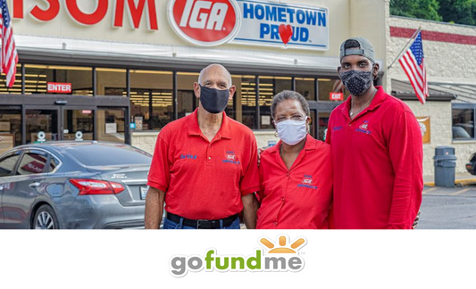 Arthur, Gwen, and Simon Christon outside Isom IGA