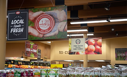Local Equals Fresh signage hangs from an IGA store