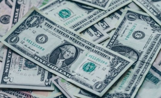 a pile of U.S. dollar and five dollar bills